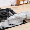 A hand wearing a cleaning glove is cleaning a black stovetop with soapy water.