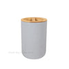 A cylindrical bathroom organizer set made of white ceramic with a wooden soap dispenser top.