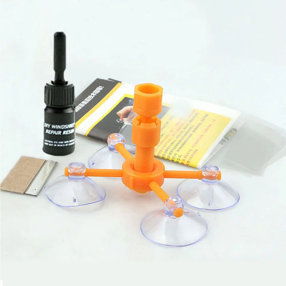 An orange DIY windshield repair kit with various tools and components is displayed on a white background.