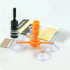 An orange DIY windshield repair kit with various tools and components is displayed on a white background.