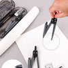 A drafting set featuring rulers, compasses, and erasers laid out on a white sheet of paper.