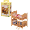 A wooden dollhouse set featuring a crib and accessories for Sylvanian Families Forest Friends.