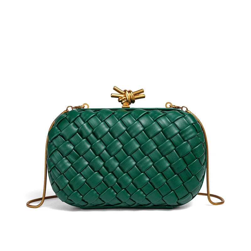 A dark green handwoven clutch bag with a quilted pattern and a gold-toned chain strap.