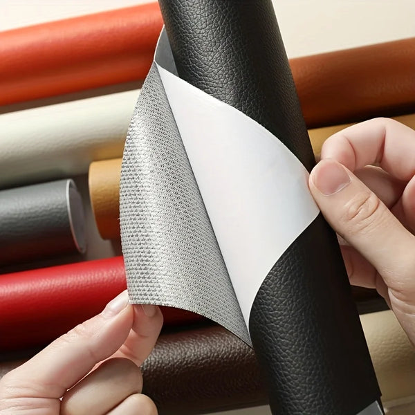 A hand is peeling back a gray self-adhesive leather repair patch tape from a black rolled product.