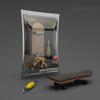 A wooden finger skateboard is shown inside its protective packaging with a wooden board and yellow wheels.
