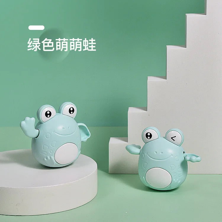 A light blue cartoon turtle toy sitting on a white stand against a mint green background.