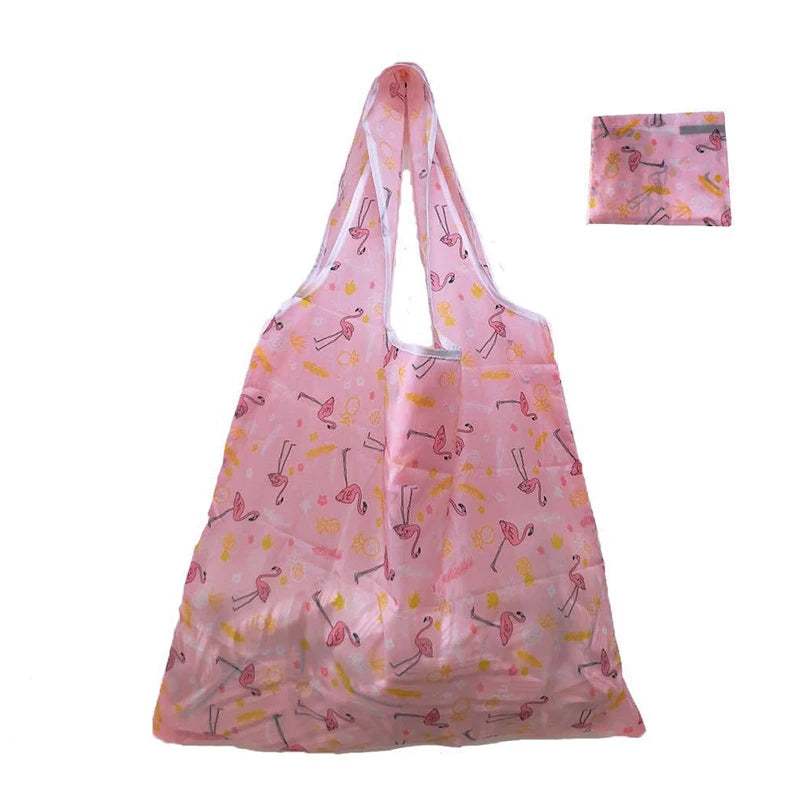 Pink foldable reusable shopping tote with a matching carry pouch featuring a pink and yellow floral pattern.