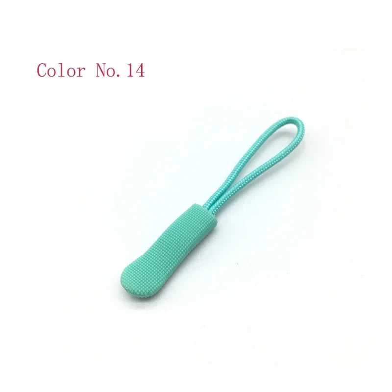 A teal plastic zipper pull with a loop attached, labeled Color No. 14.