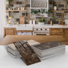 A stack of brown and beige marble self-adhesive wall stickers or 3D tile decals for kitchen and bathroom decor.