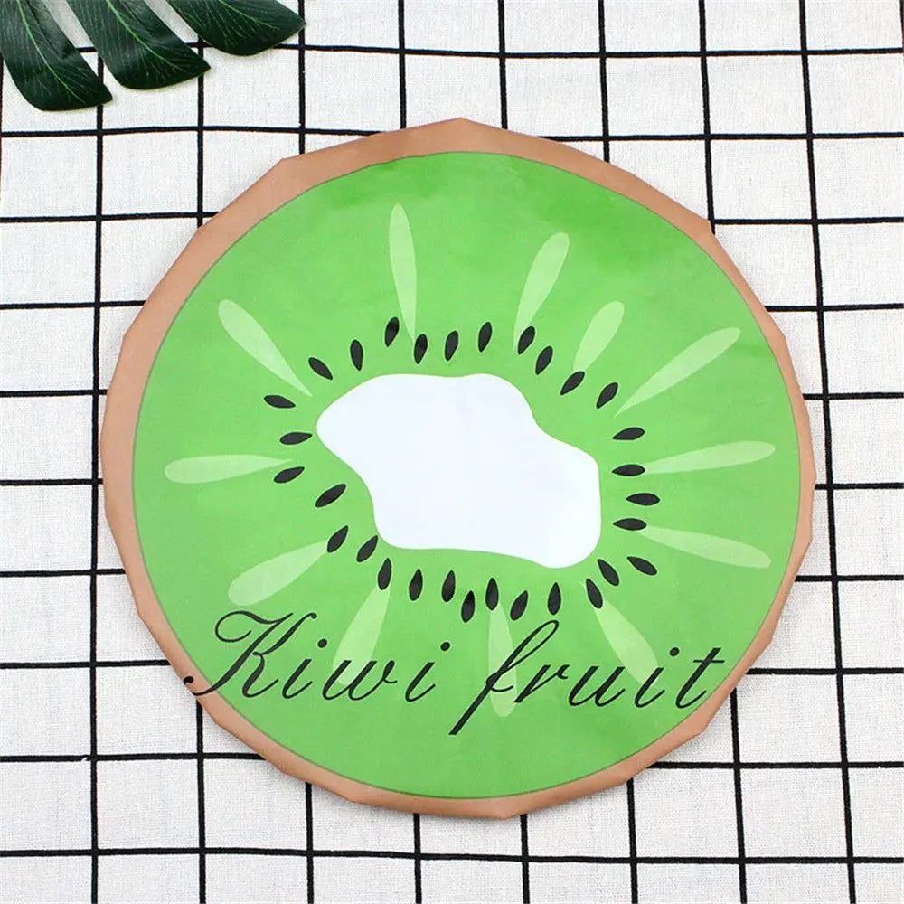 A circular green kiwi fruit design on a brown background placed on a black and white checkered cloth.