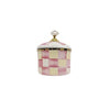 A vintage porcelain storage jar with a lid featuring a pink and cream checkerboard pattern.