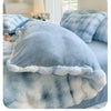 A light blue and white fluffy fleece duvet cover with a rabbit design displayed on a bed.