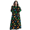 A woman wearing an oversized black hoodie blanket featuring a colorful dinosaur print.