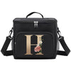 Black insulated canvas lunch bag with a gold initial H and floral design