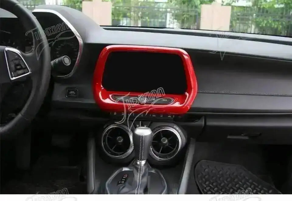 Interior view of a car showing red trim, including the dashboard, center console, and gear shifter.