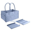 A light blue portable canvas diaper storage organizer with handles and multiple flat storage trays.