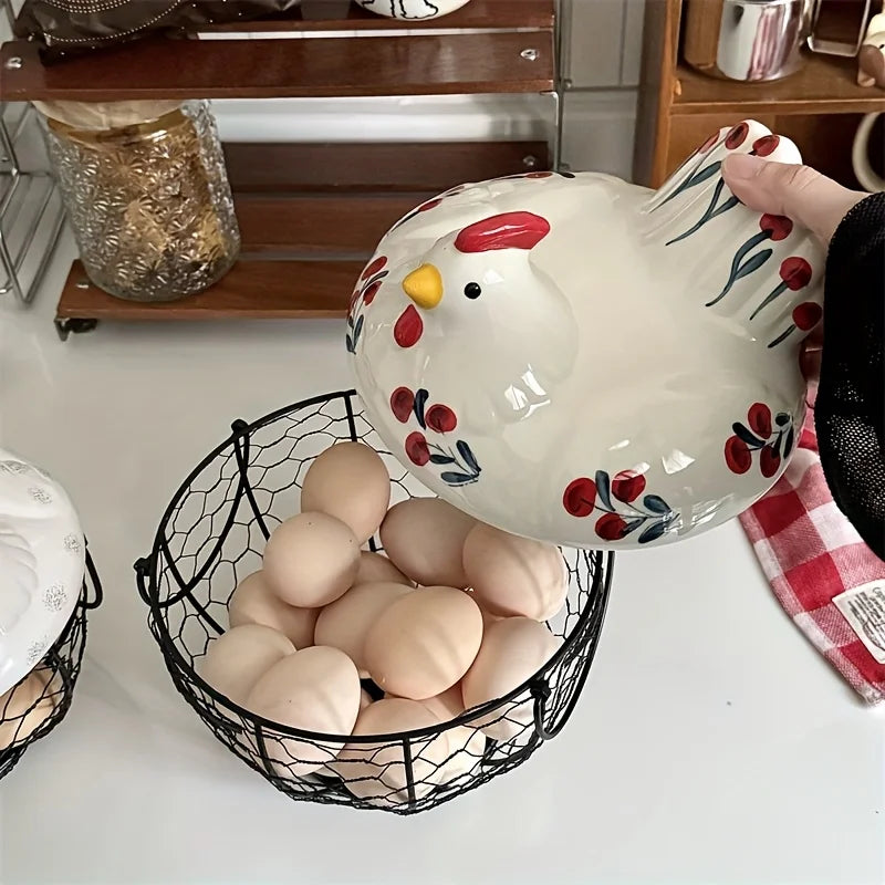 A white ceramic hen-shaped egg basket with a lid is shown next to a pile of brown eggs.