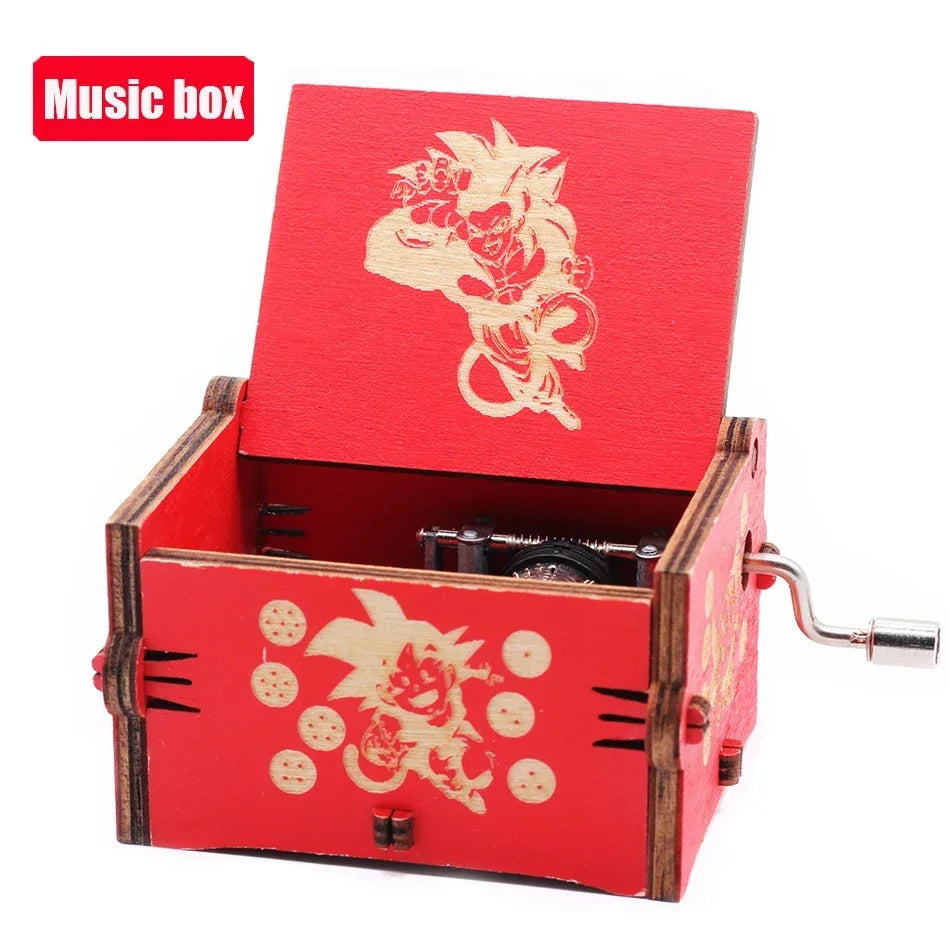A vintage red wooden music box with a hand crank and a gold-colored decorative design on the lid.
