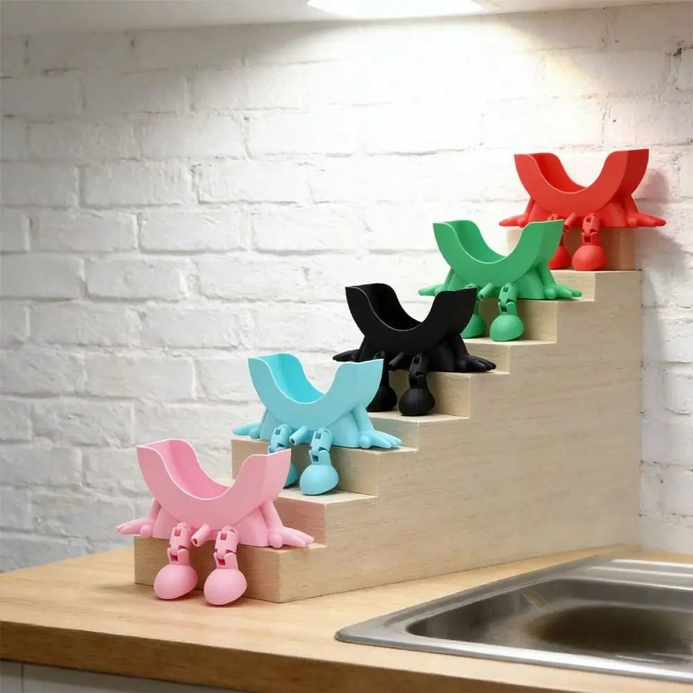 A set of colorful 3D sponge holders with hanging designs arranged on a wooden staircase against a white brick wall.