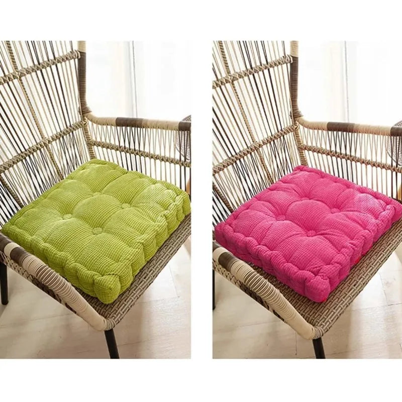 A thick corduroy floor cushion in lime green and magenta rests on a woven rattan chair.