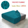 A teal velvet fabric sofa cover displayed on a modern gray sofa, showing the texture and drape of the fabric.