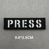 Black rectangular press patch with white text and dimensions 9.0x2.5cm