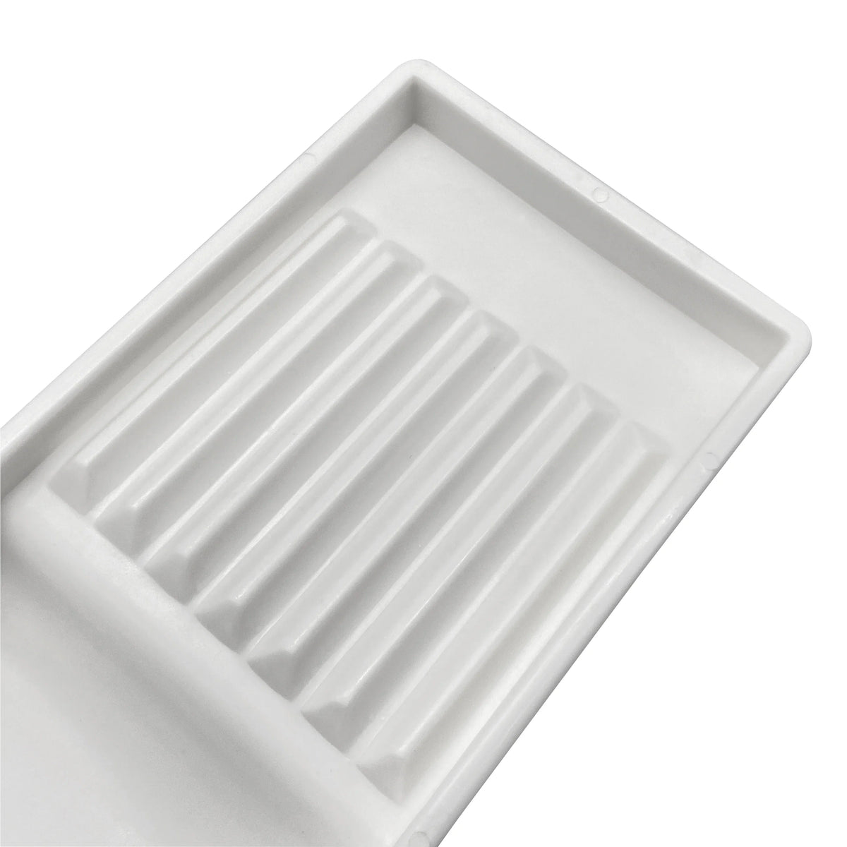 White plastic drawer organizer tray with ribbed compartments for storing dental instruments