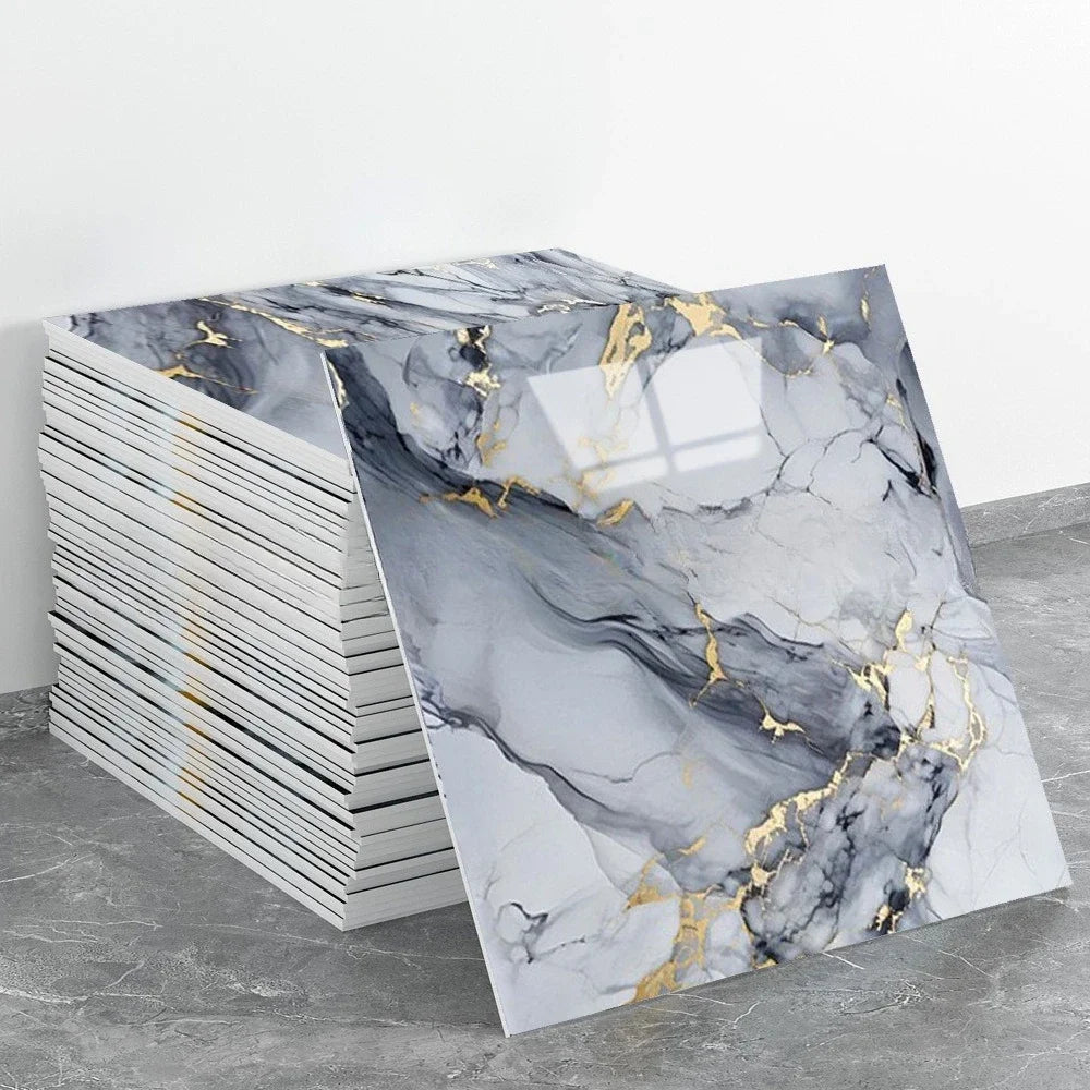Rolls of peel-and-stick marble wall tiles featuring gray and black marble patterns with gold accents