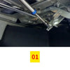 Close-up view of a universal adjustable trunk lift spring kit showing the coiled spring and mounting hardware.