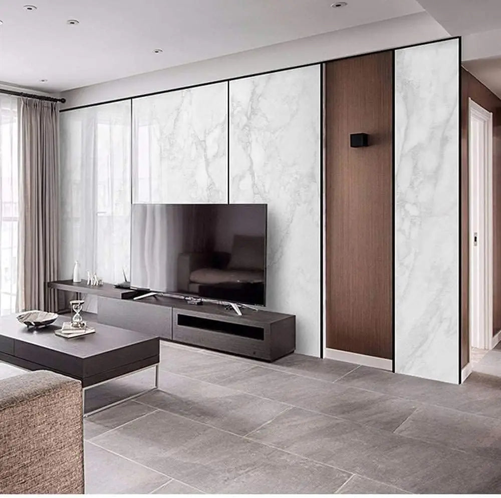 Modern kitchen design featuring a large television mounted above a dark cabinet and marble-patterned wall panels.