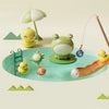 A green and yellow kids electric kitchen sink playset featuring animals, a fishing rod, and running water.