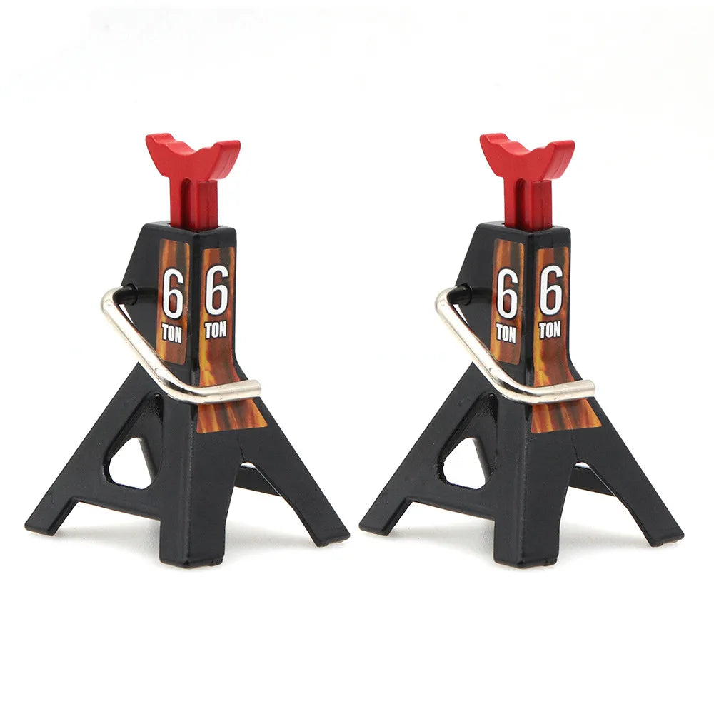 A pair of black metal RC jack stands with red handles and '6 TON' markings.