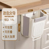 A large gray white foldable hanging trash bin is shown mounted under a wooden cabinet shelf.