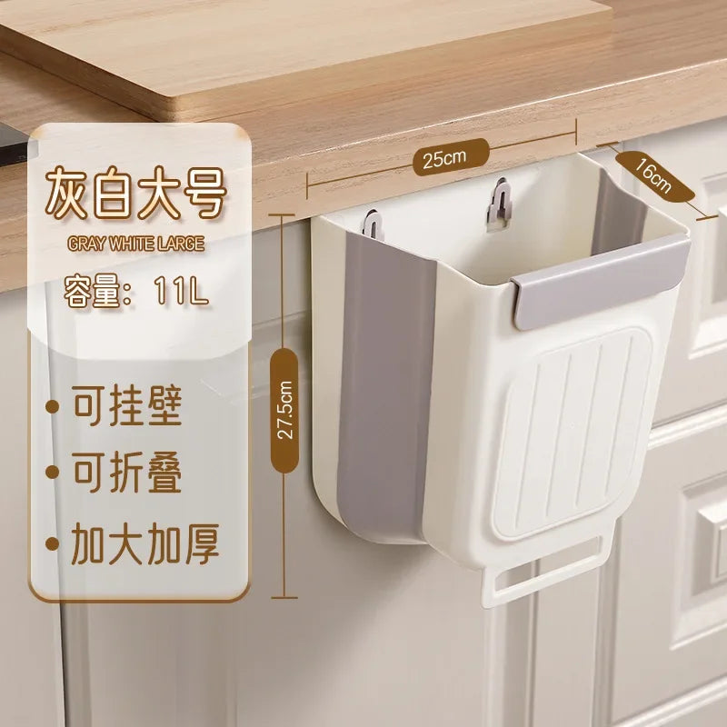 A large gray white foldable hanging trash bin is shown mounted under a wooden cabinet shelf.