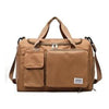 A tan waterproof travel duffle bag with a top handle and an exterior shoe compartment.