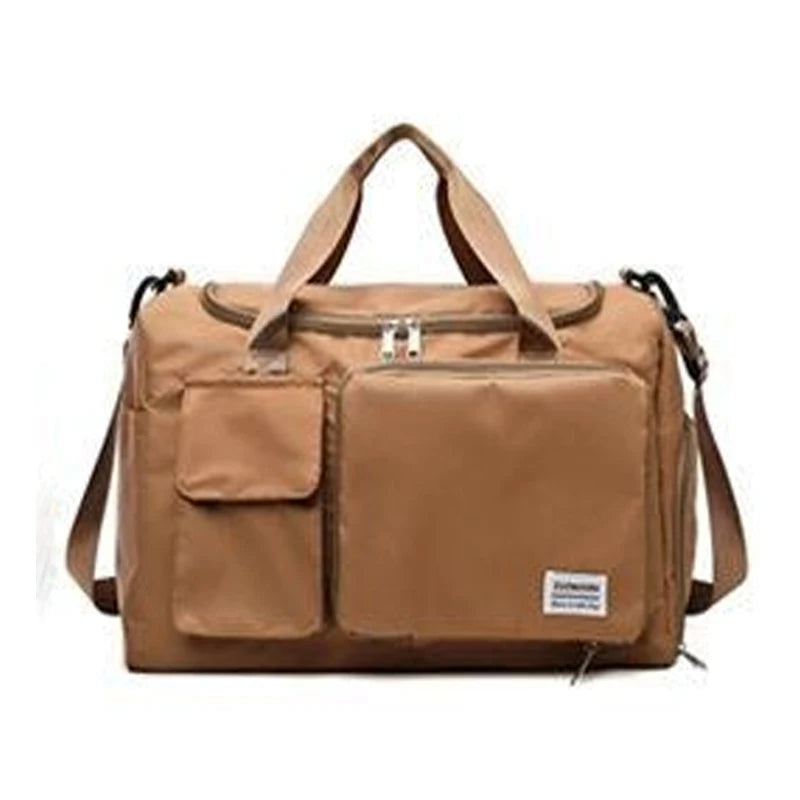 A tan waterproof travel duffle bag with a top handle and an exterior shoe compartment.