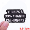 Black embroidered iron-on letter patch with white text that reads There's a 99% chance I'm hungry