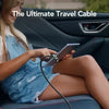 A young woman is using a multi USB-C cable in the interior of a car, likely for charging or data sync.
