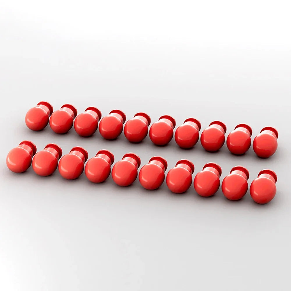 A row of small, round, red reusable toy gun shells or darts.