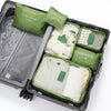 A set of six green and beige travel packing cubes and laundry pouches stored in a gray plastic case.
