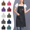 A collection of oil-proof canvas aprons in various colors and styles displayed on a model.
