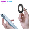 A hand holds a silver magnetic phone holder ring stand, demonstrating its use for securing a smartphone.
