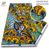 A bolt of pink glitter African wax print fabric featuring a vibrant yellow and green floral pattern.