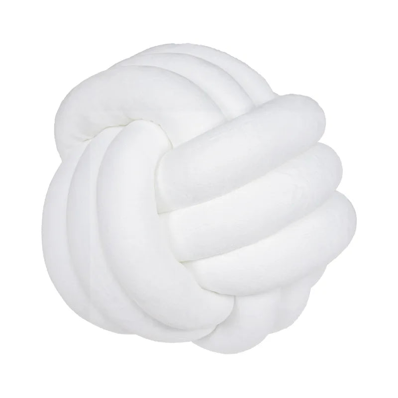 A white, hand-knotted velvet throw pillow with a round, textured design.