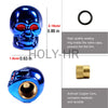 A blue skull design tire valve stem cap and a brass core are shown.