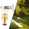 A silver garden hose tap adapter with a brass connector is shown next to a bright sunbeam hitting a green lawn.
