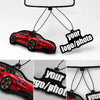 A red sports car is suspended by black strings, featuring a custom photo tag for an air freshener.