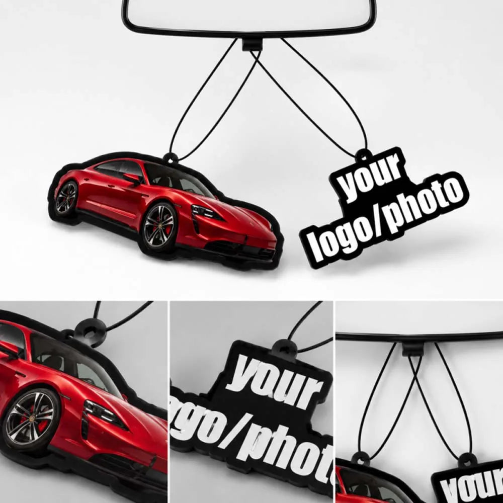 A red sports car is suspended by black strings, featuring a custom photo tag for an air freshener.