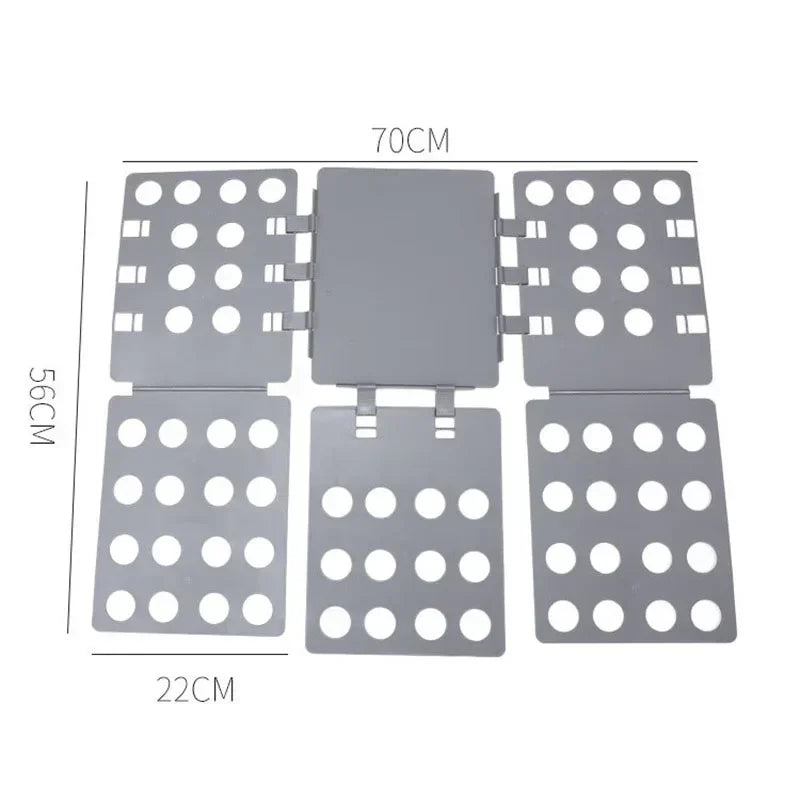 A gray magic clothes folding board with multiple circular holes for organizing t-shirts.