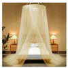 A sheer beige canopy mosquito net draped over a double bed in a bedroom setting.